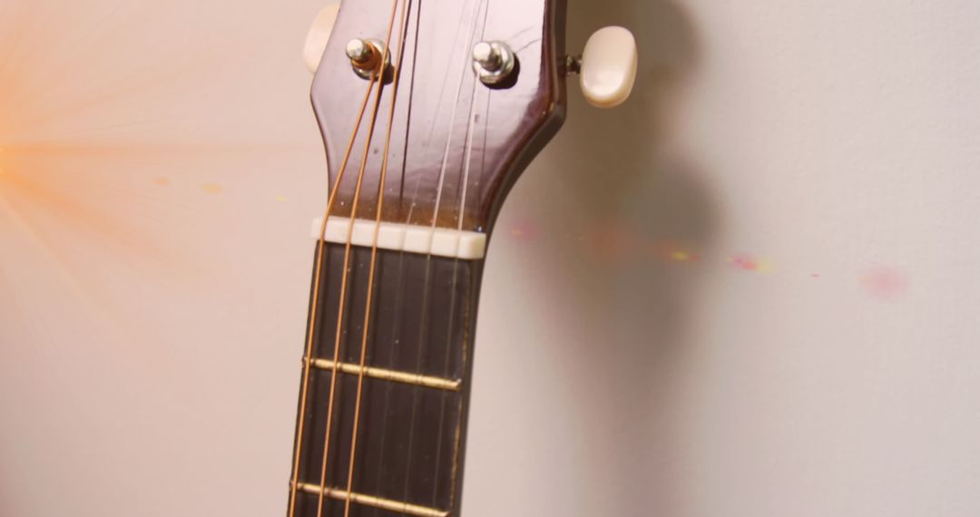 Close-up of acoustic guitar headstock and tuning pegs