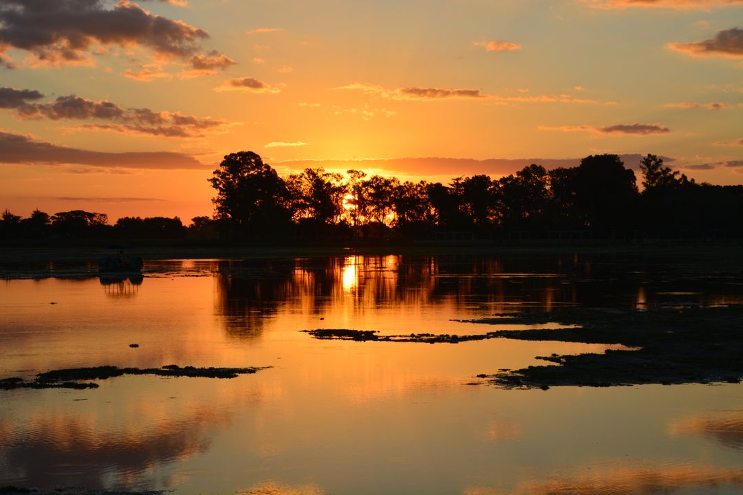 Beautiful Golden Sunset Over Lake with Reflective Water Surface - Free Images, Stock Photos and Pictures on Pikwizard.com