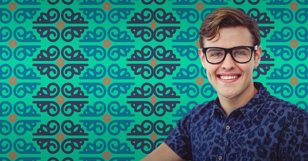 Smiling Man with Glasses in Front of Vibrant Teal Patterned Background - Free Images, Stock Photos and Pictures on Pikwizard.com
