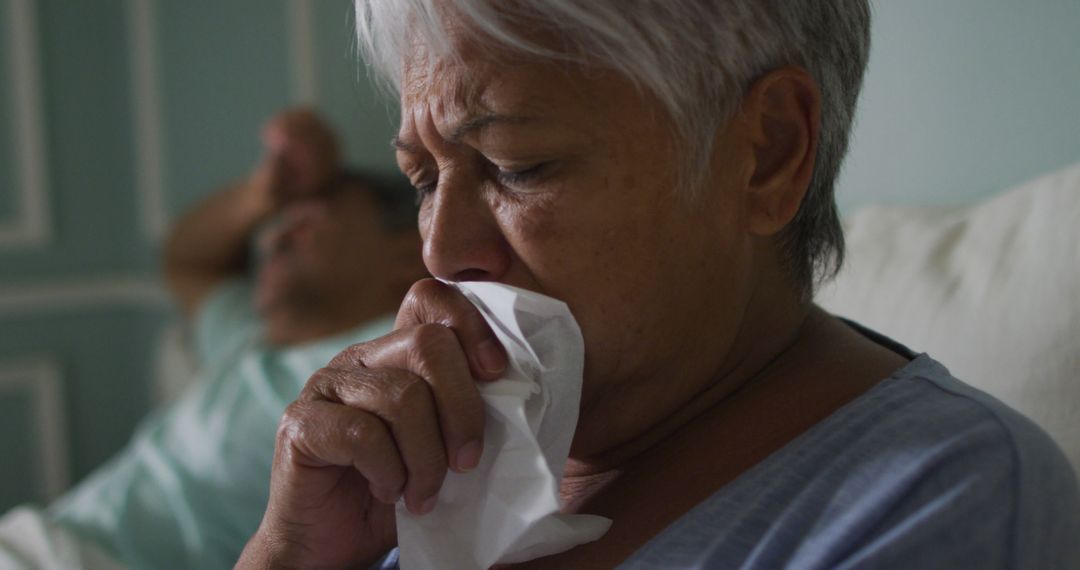 Senior Woman Suffering from Cough with Concerned Partner in Background - Free Images, Stock Photos and Pictures on Pikwizard.com