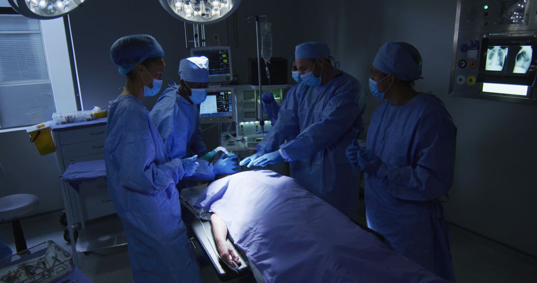 Surgeons Performing Operation Under Blue Light in Operating Room - Free Images, Stock Photos and Pictures on Pikwizard.com