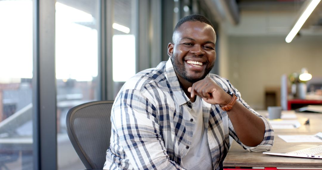 Smiling Entrepreneur Working at Office Desk