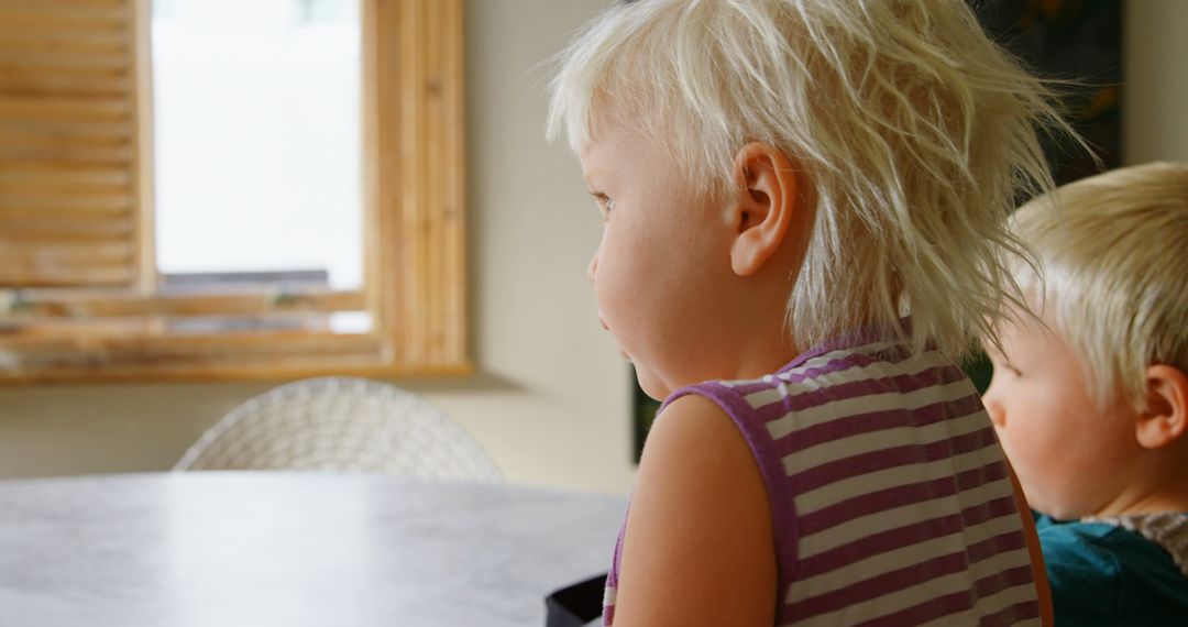 Siblings Engaged in Virtual Reality Experience at Home