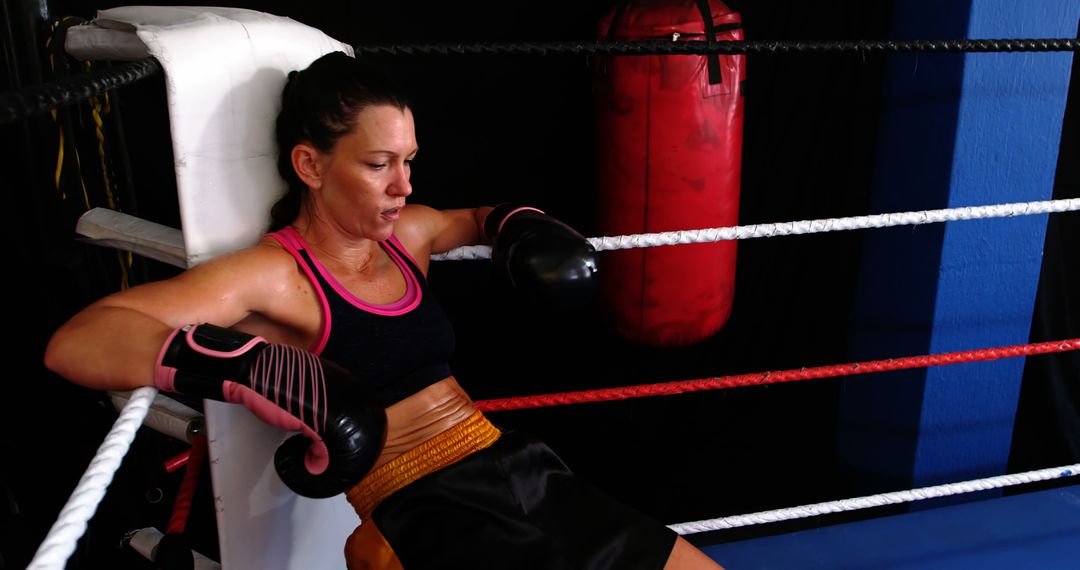 Female Boxer Taking a Break in Boxing Ring - Free Images, Stock Photos and Pictures on Pikwizard.com