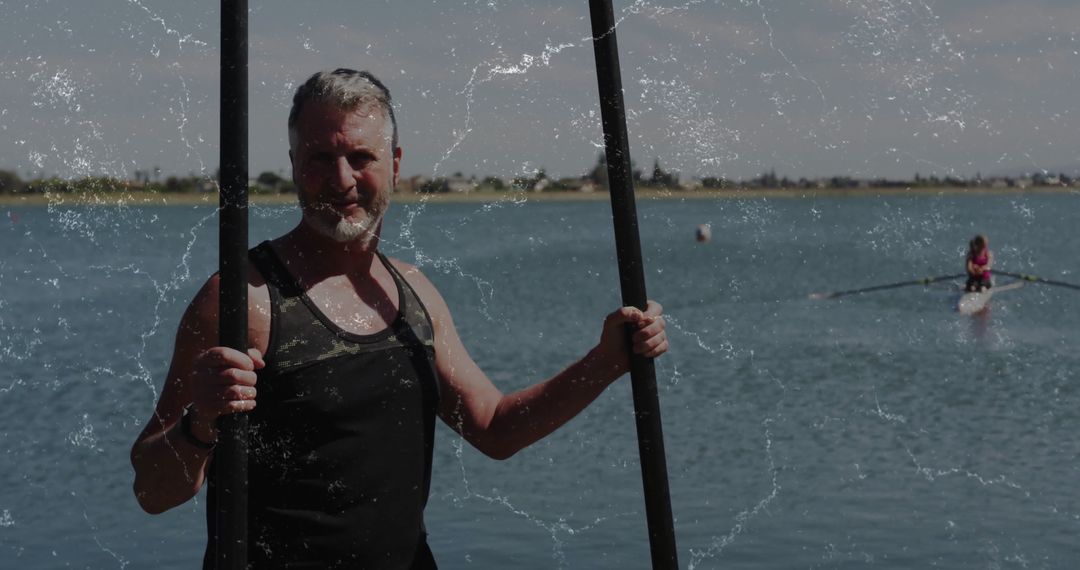 Senior Man Paddle Boarding on Tranquil Lake with Paddles