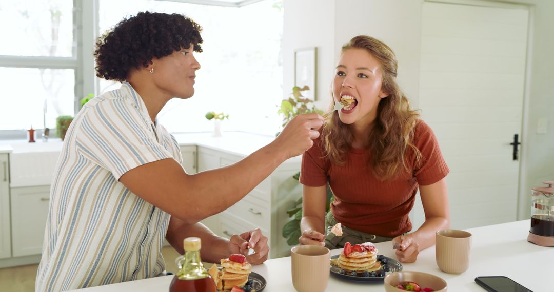 Couple Sharing Pancake Breakfast at Modern Kitchen Island