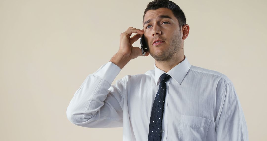 Confident Businessman Talking on Smartphone in White Shirt and Tie - Free Images, Stock Photos and Pictures on Pikwizard.com