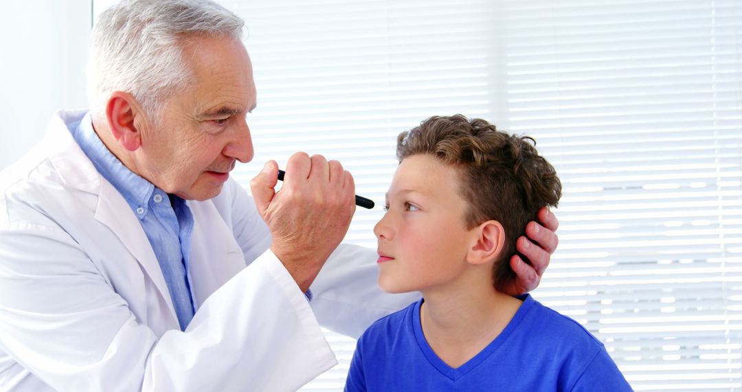 Doctor Checking Child's Eye with Pen Light - Free Images, Stock Photos and Pictures on Pikwizard.com