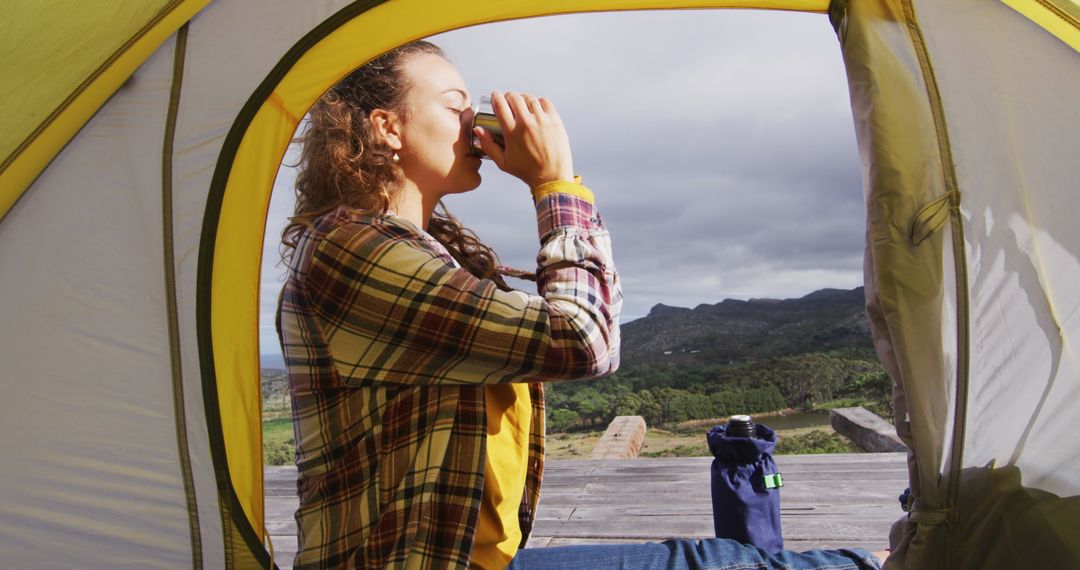 Woman Enjoying Hot Drink Inside Camping Tent with Mountain View - Free Images, Stock Photos and Pictures on Pikwizard.com