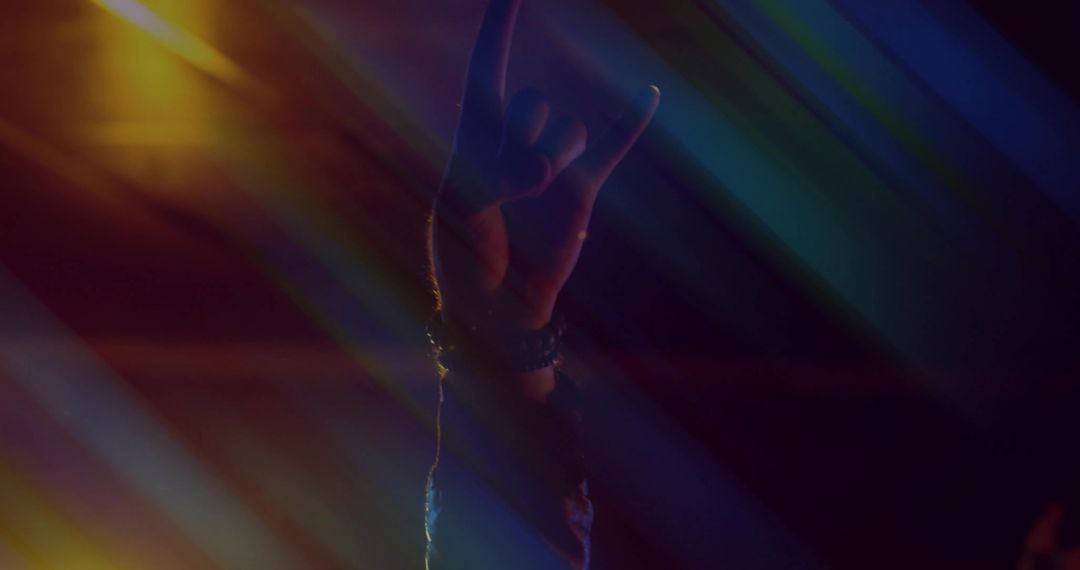 Rock Hand Gesture in Concert Lighting Capturing Music Show Energy