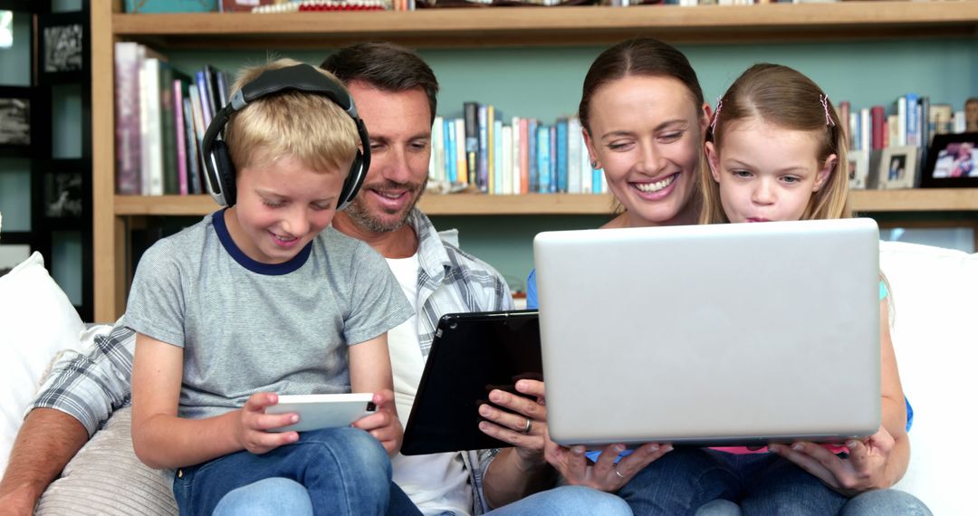 Happy Family Using Technology Together on Sofa - Free Images, Stock Photos and Pictures on Pikwizard.com