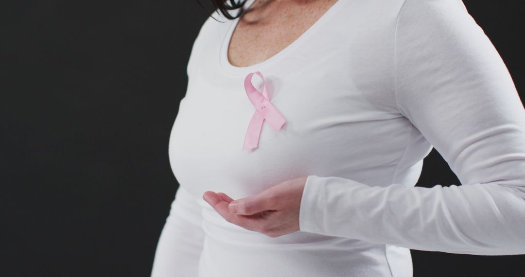 Close-up of Woman Wearing Pink Ribbon Symbolizing Breast Cancer Awareness - Free Images, Stock Photos and Pictures on Pikwizard.com