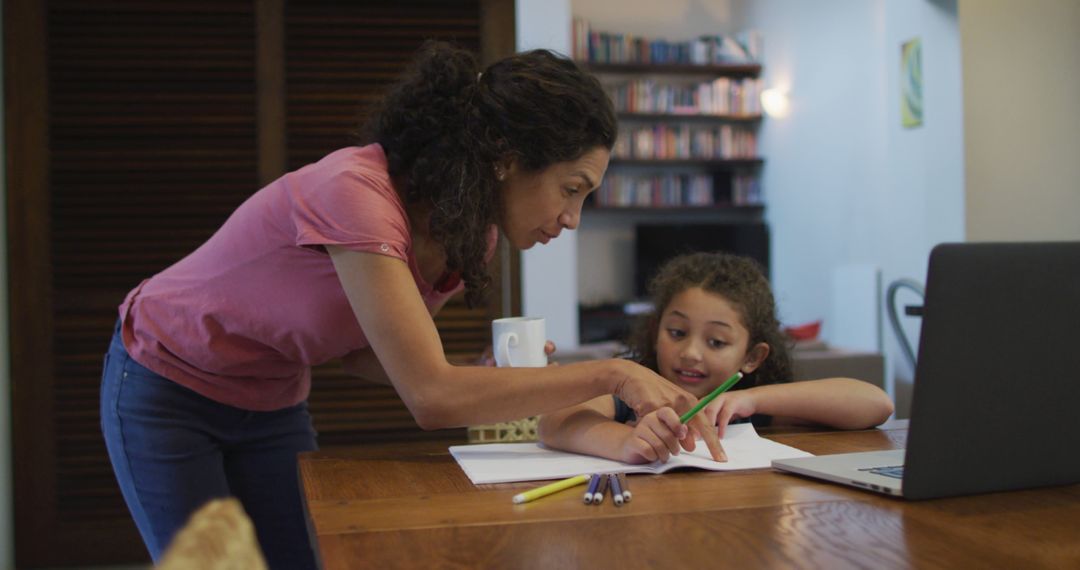 Mother Helping Daughter with Homework at Table - Free Images, Stock Photos and Pictures on Pikwizard.com