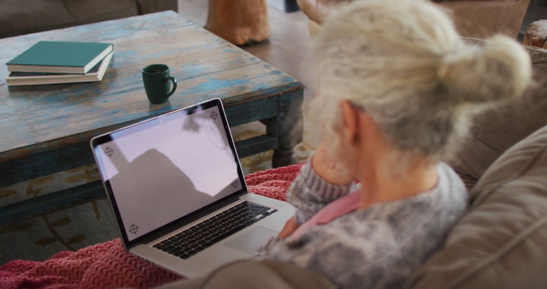 Elderly Woman Relaxing at Home Using Laptop - Free Images, Stock Photos and Pictures on Pikwizard.com