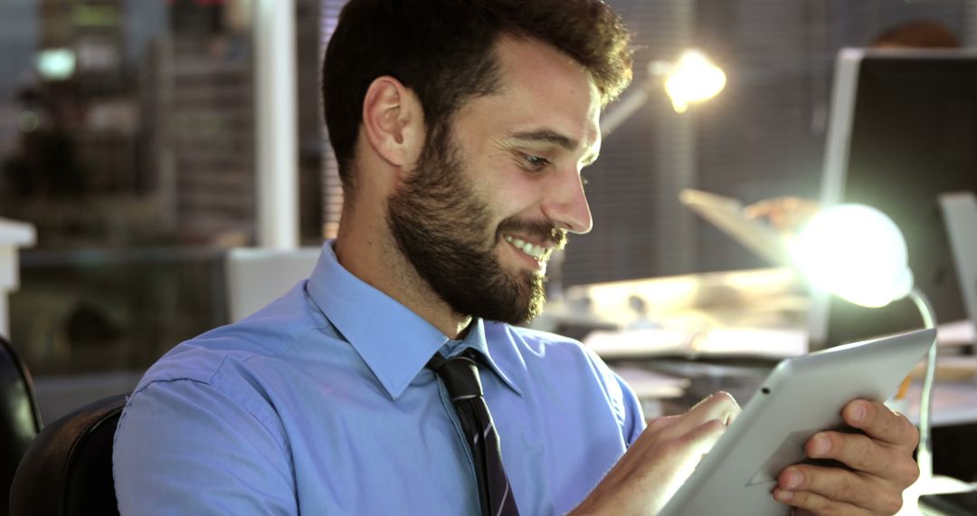 Smiling Professional Using Tablet In Modern Office - Free Images, Stock Photos and Pictures on Pikwizard.com