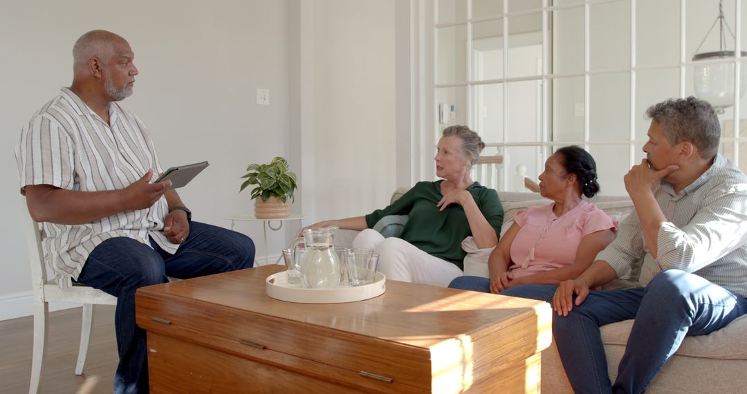 Senior Group Enjoying Discussion at Home, Emphasizing Conversation and Togetherness