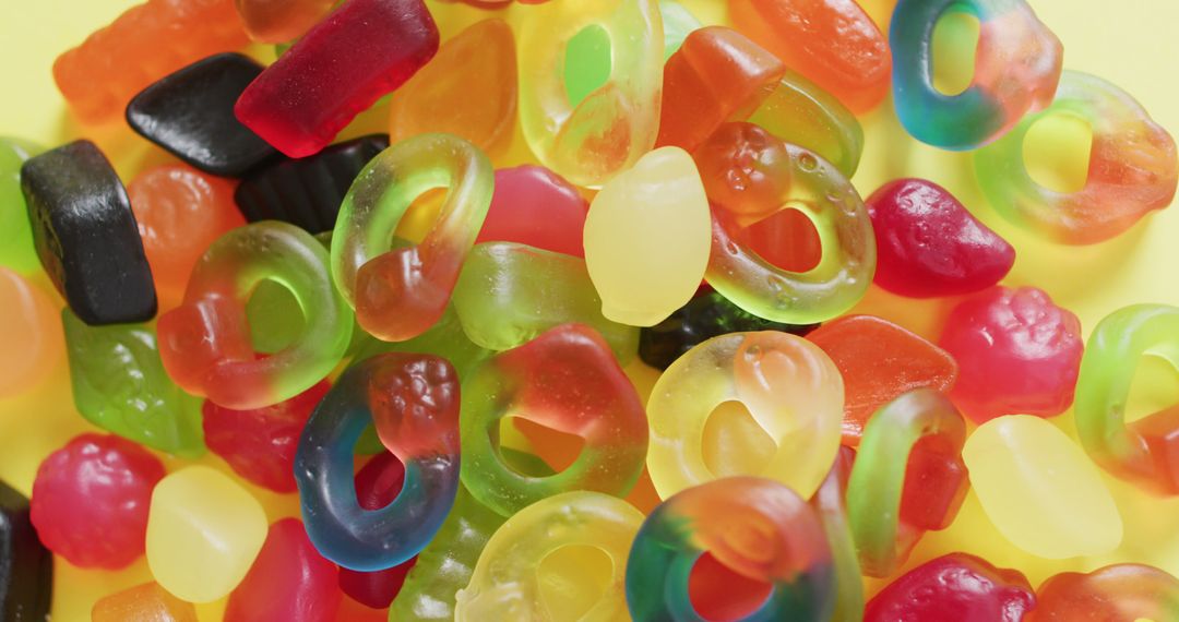 Colorful Assortment of Gummy Candies on Yellow Background - Free Images, Stock Photos and Pictures on Pikwizard.com