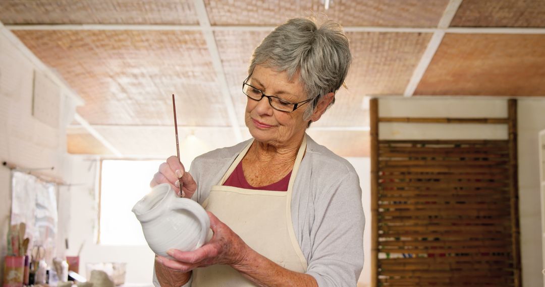 Senior Woman Painting Ceramic Pot in Art Studio - Free Images, Stock Photos and Pictures on Pikwizard.com