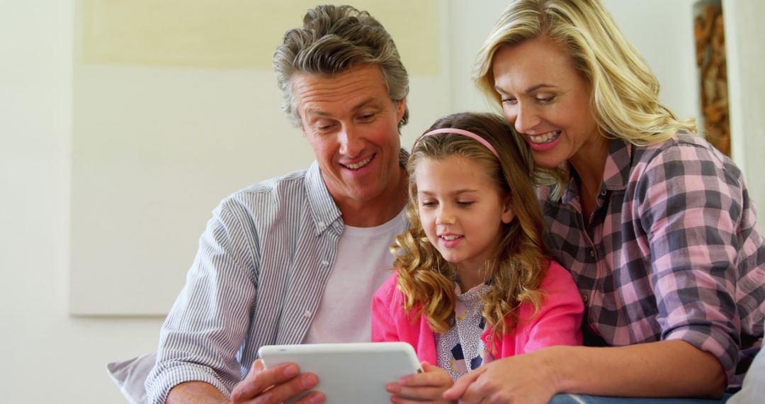 Parents and Young Daughter Using Tablet at Home - Free Images, Stock Photos and Pictures on Pikwizard.com