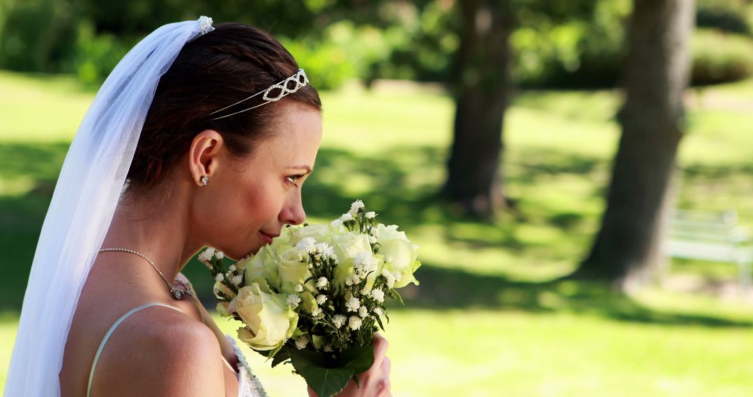 Bride in Veil Enjoying Wedding Bouquet Outdoors - Free Images, Stock Photos and Pictures on Pikwizard.com