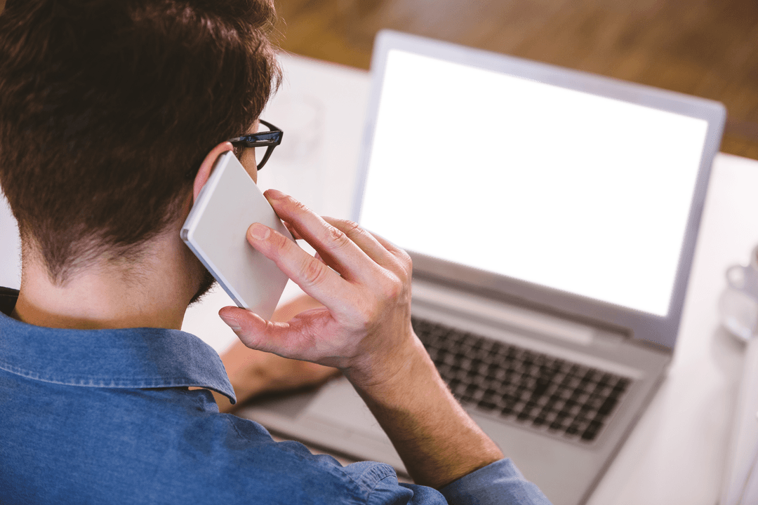 Transparently Connected Businessman Using Laptop and Phone