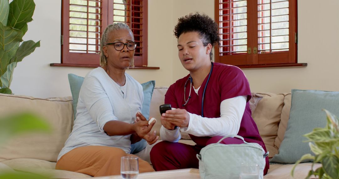 Caregiver Assisting Senior Woman with Glucometer at Home