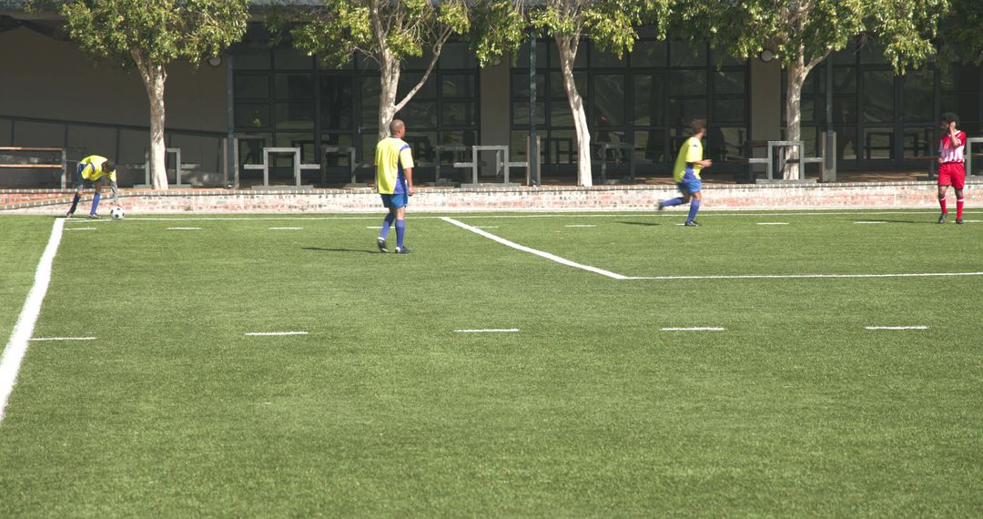 Youth Soccer Players Practicing on a Sunny Field