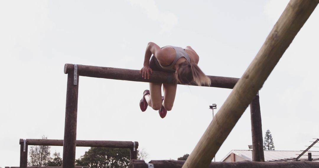 Athletic Woman Climbing Over Obstacle in Outdoor Training - Free Images, Stock Photos and Pictures on Pikwizard.com