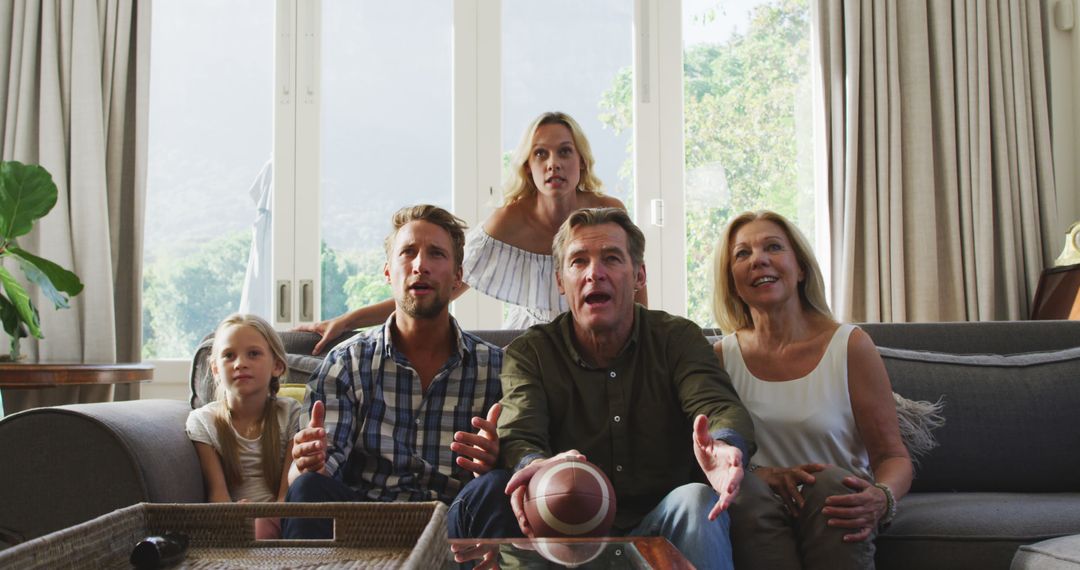 Excited Family Watching Sports Game on Television - Free Images, Stock Photos and Pictures on Pikwizard.com