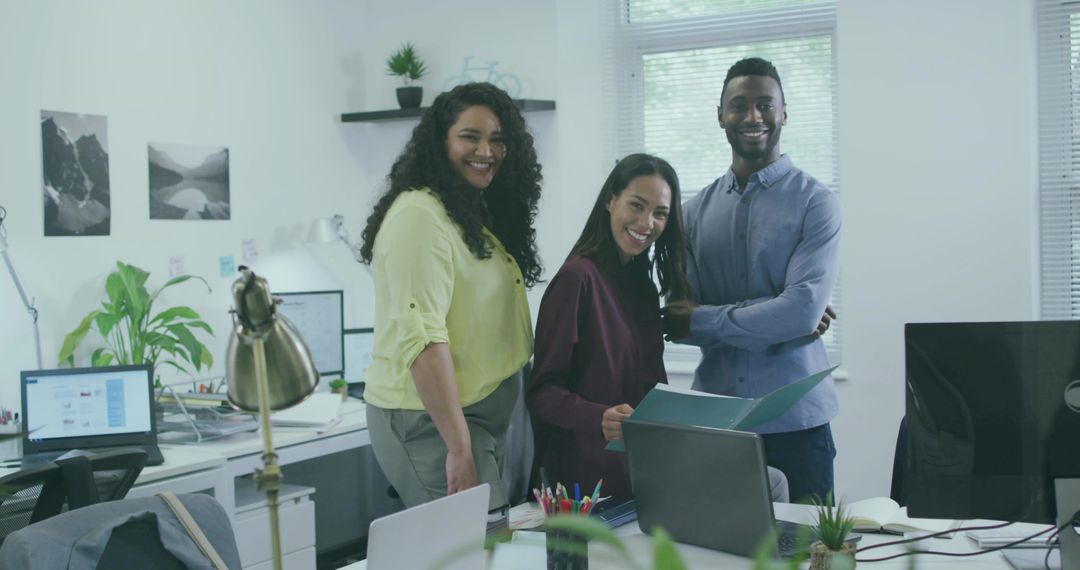 Smiling Coworkers in Modern Office Environment Collaborating on Project