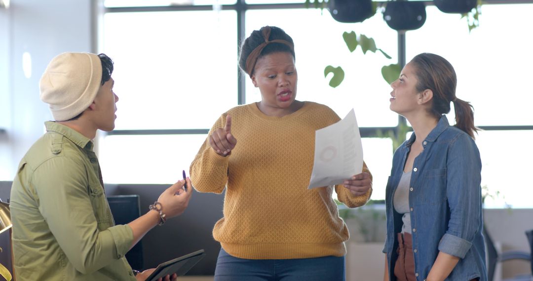 Diverse Team Collaborating in Modern Office African-American Leader Pointing at Report