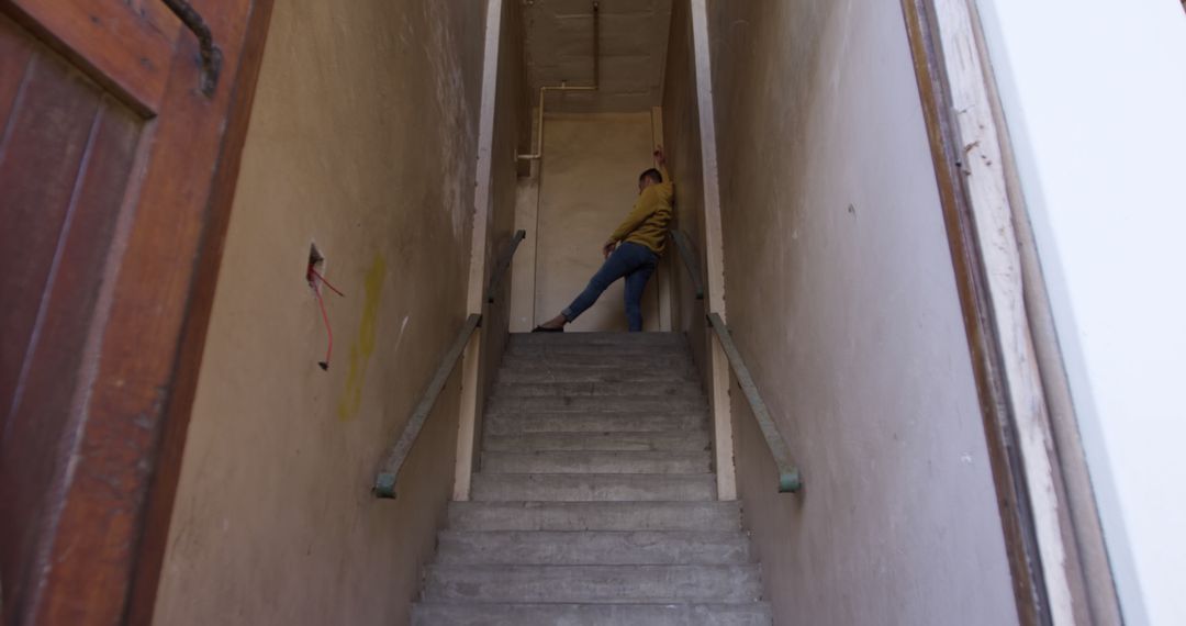 Expressive Caucasian Male Dancing in an Abandoned Staircase