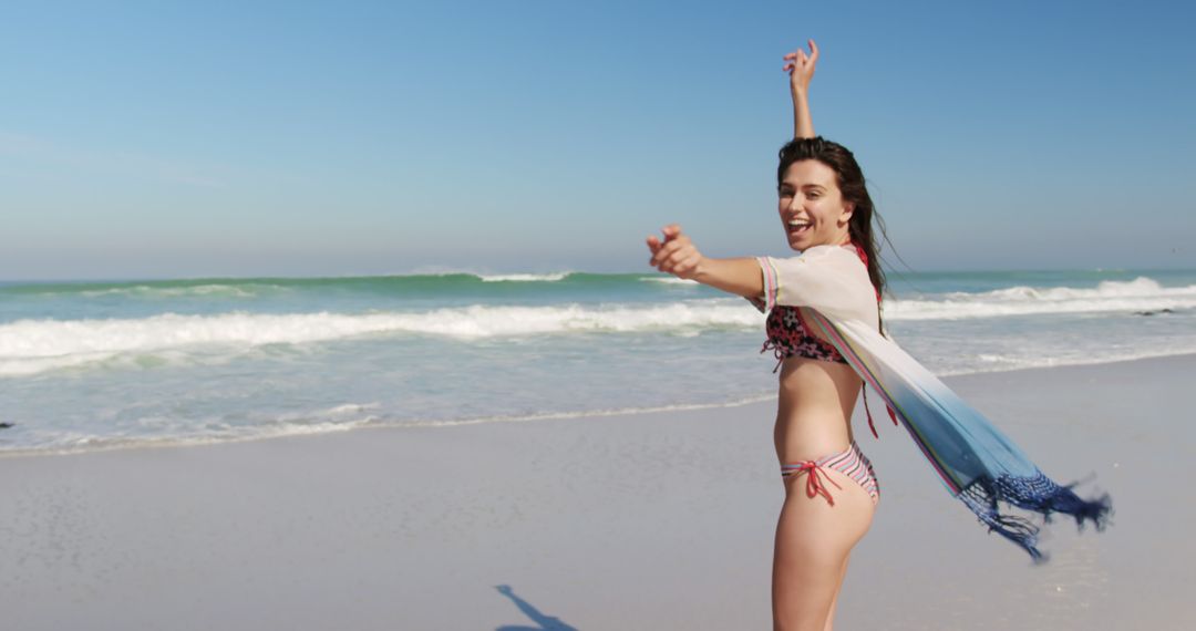 Happy Woman in Bikini Smiling and Dancing on Sandy Beach - Free Images, Stock Photos and Pictures on Pikwizard.com