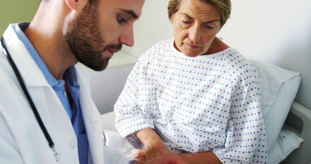 Doctor Consulting Concerned Senior Woman Patient in Hospital Room - Free Images, Stock Photos and Pictures on Pikwizard.com