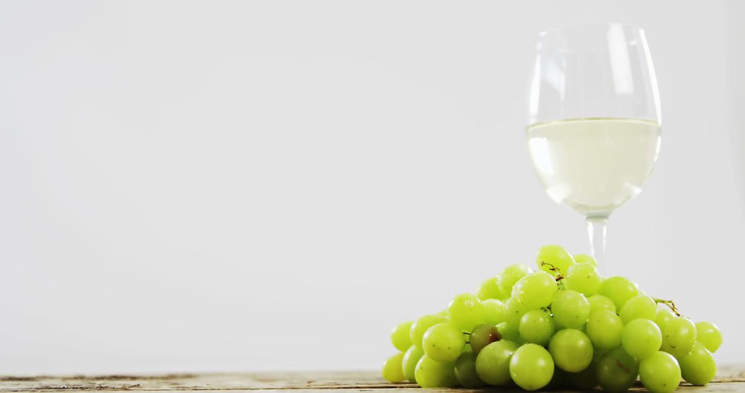 Glass of White Wine with Fresh Green Grapes on Rustic Table - Free Images, Stock Photos and Pictures on Pikwizard.com