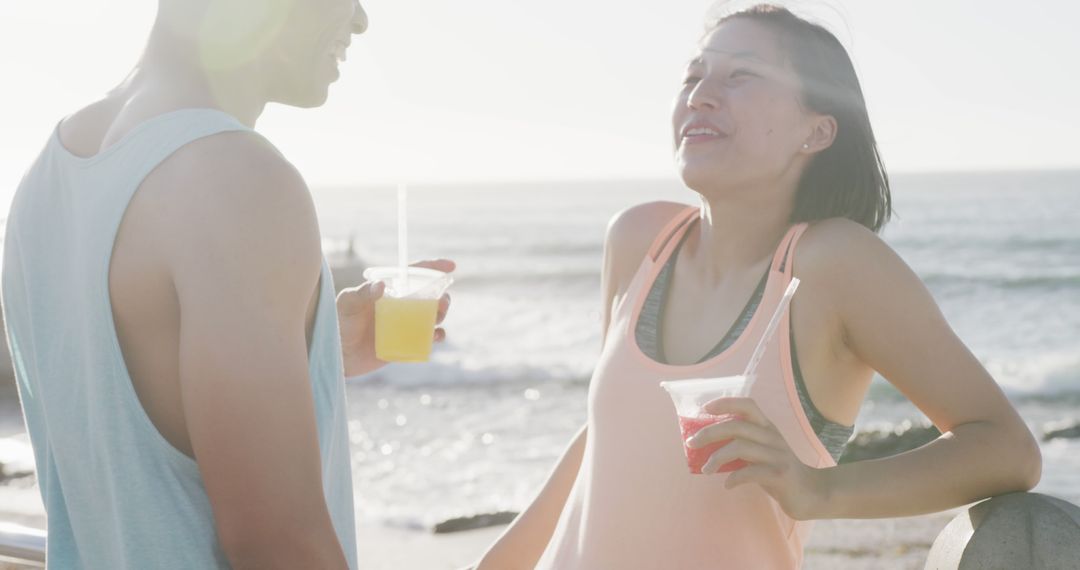 Happy Couple Enjoying Summertime Drinks by the Seaside