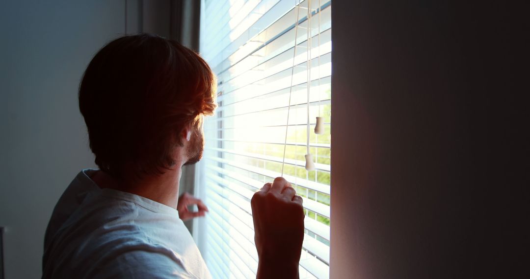 Man Looking Through Window Blinds at Dawn from Home - Free Images, Stock Photos and Pictures on Pikwizard.com