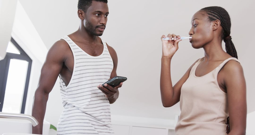 Couple Engaging in Morning Routine with Smartphones