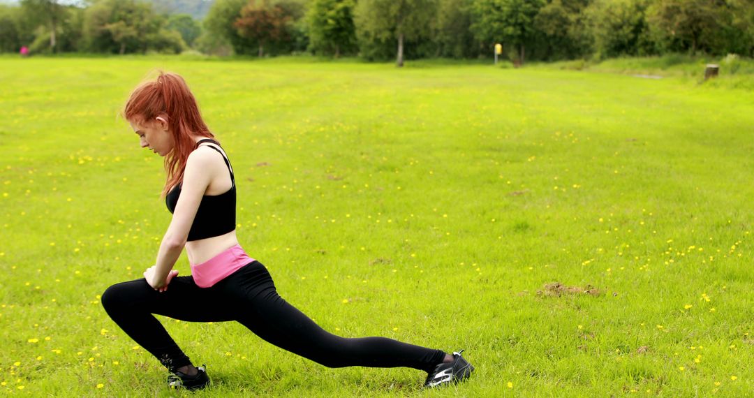 Young Woman Stretching Outdoors in a Green Field - Free Images, Stock Photos and Pictures on Pikwizard.com