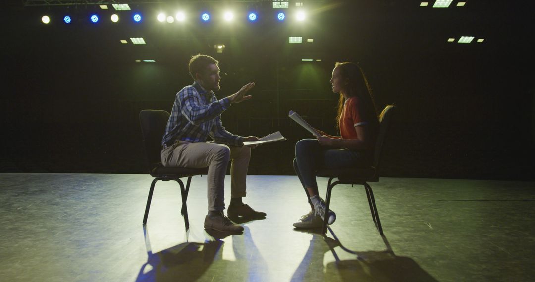 Actors Rehearsing on Dimly Lit Stage with Backlighting - Free Images, Stock Photos and Pictures on Pikwizard.com