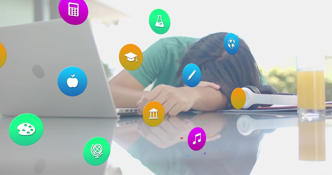 Overwhelmed student resting head on arms at desk with laptop and floating education icons