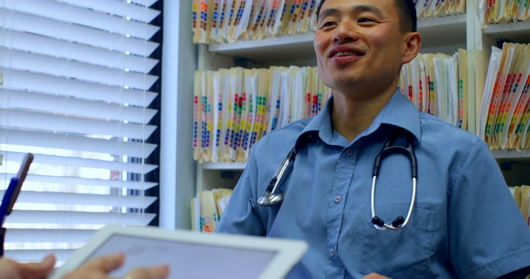 Male Doctor Smiling During Consultation with Patient - Free Images, Stock Photos and Pictures on Pikwizard.com