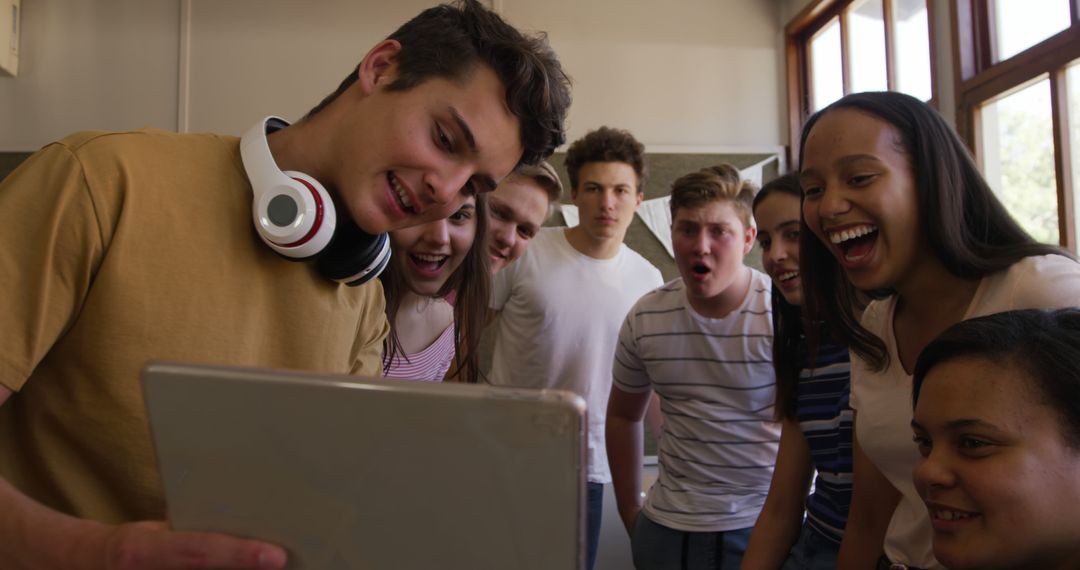 Diverse Group of Teenagers Laughing And Enjoying Tablet Content Together - Free Images, Stock Photos and Pictures on Pikwizard.com