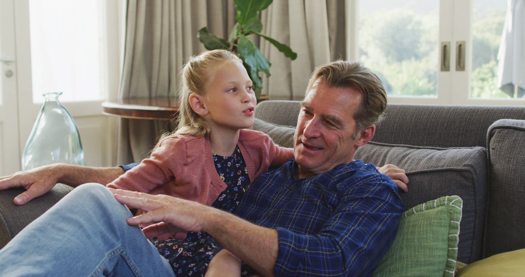 Father and Daughter Sharing a Happy Moment on Couch - Free Images, Stock Photos and Pictures on Pikwizard.com