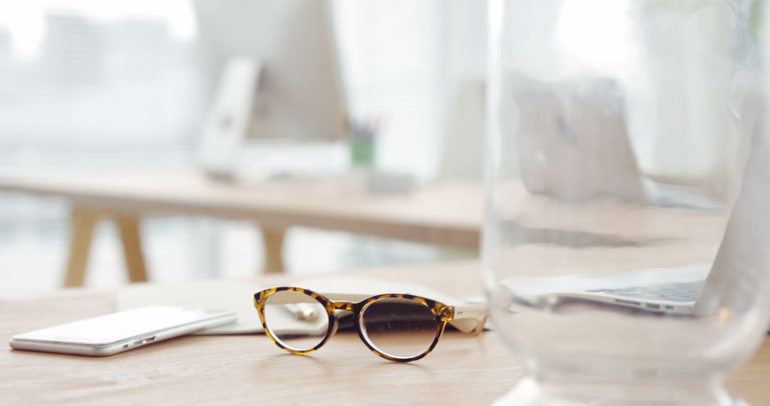 Contemporary Workspace with Glasses and Electronics on Desk