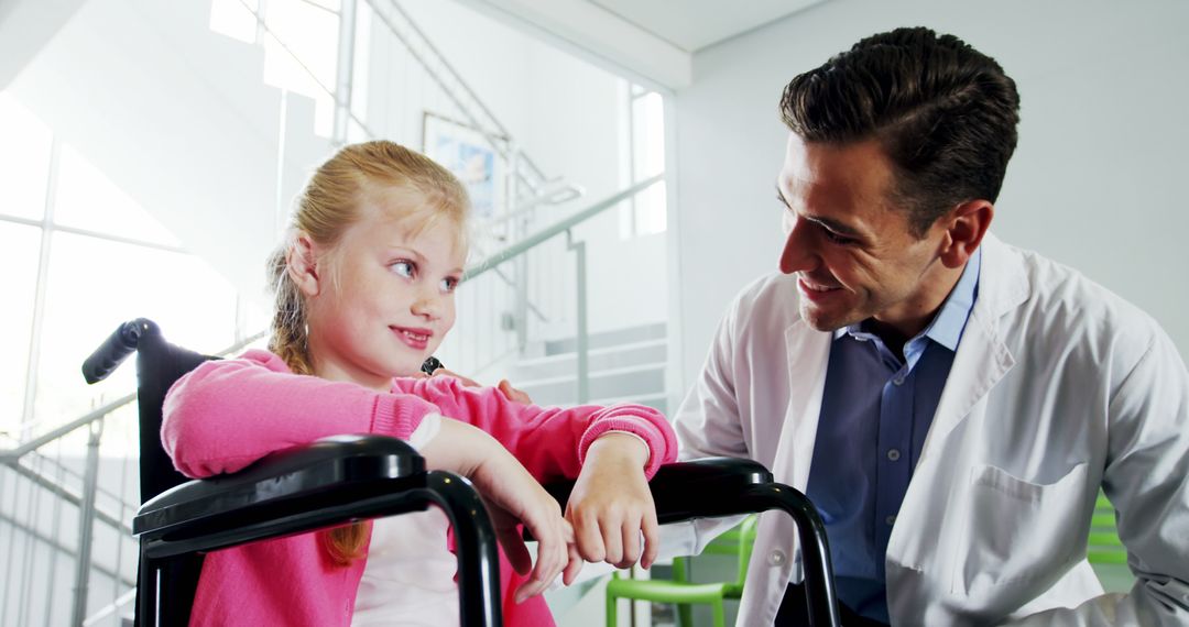 Doctor Comforting Young Girl in Wheelchair - Free Images, Stock Photos and Pictures on Pikwizard.com