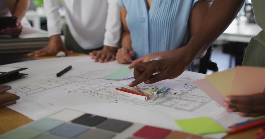 Diverse Team Collaborating on Design Project with Color Samples
