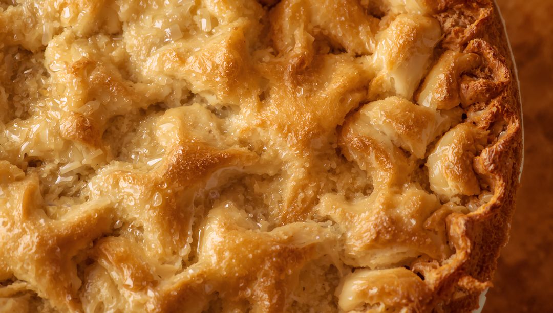 Golden lattice pie showing glossy caramelized crust and flaky pastry