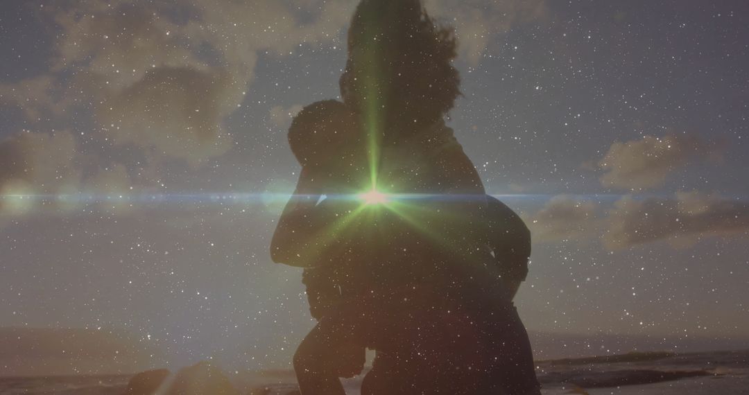 Silhouette of Parent with Child on Beach at Sunset
