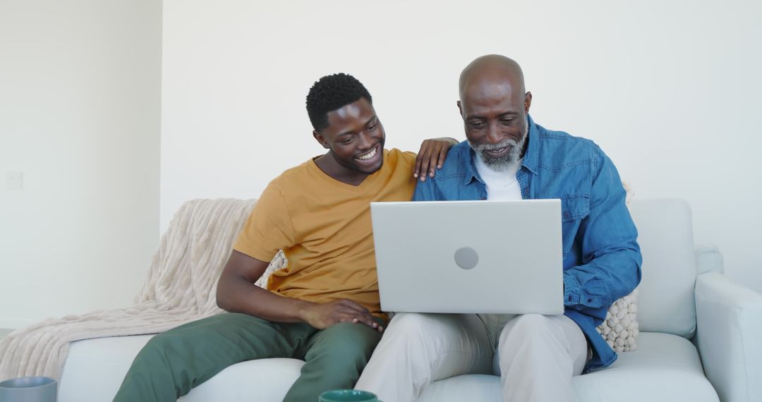Father and Son Using Laptop at Home Embracing Family Connection
